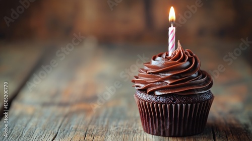 Chocolate Cupcake With a Candle on Rustic Wooden Table for a Birthday Celebra...