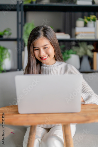 Free Download Relaxation concept, Happy asian woman working with laptop at home in the morning - GFXLoad