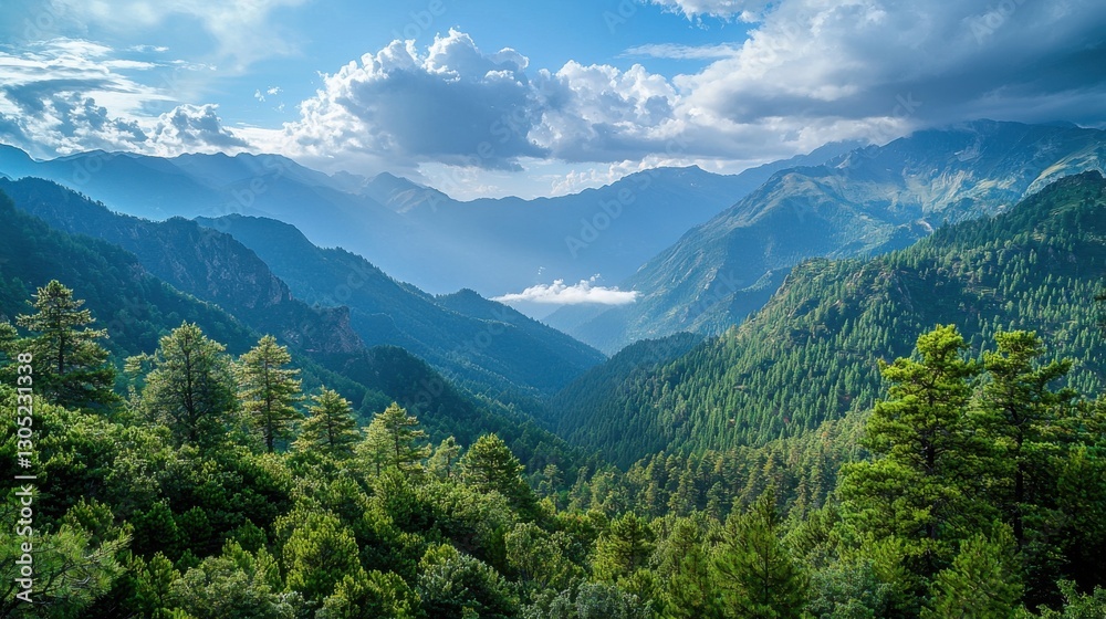 Fototapeta premium Majestic mountain range under a partly cloudy sky. Lush green forests cover the lower slopes, creating a breathtaking view of nature's beauty.