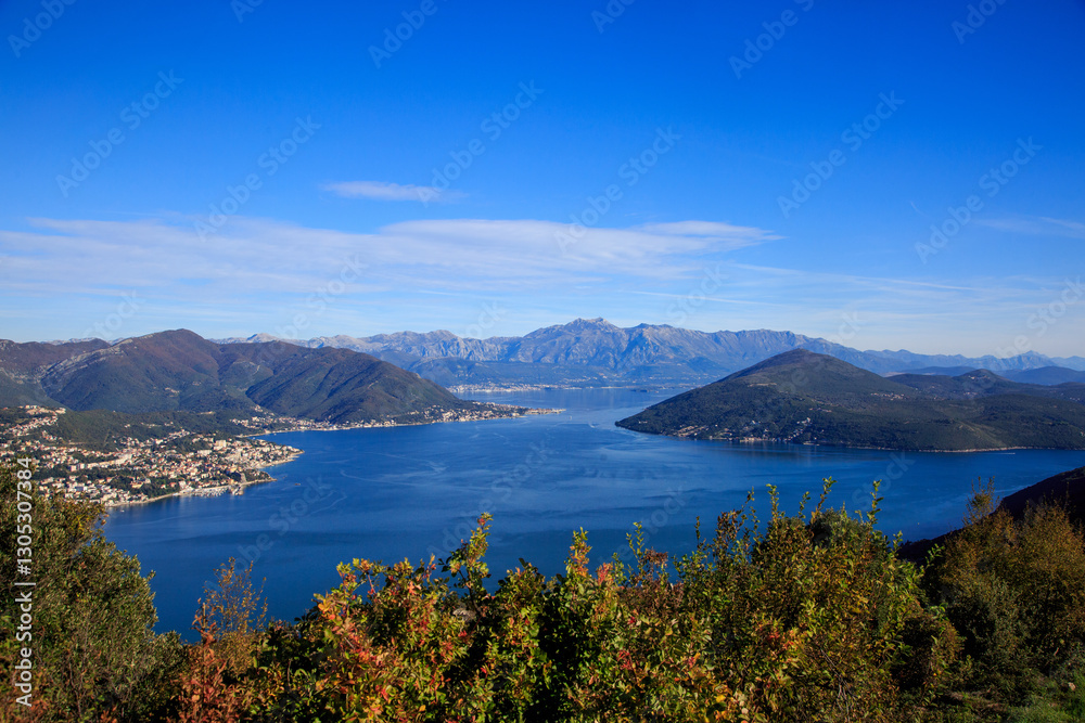 panoramic view of a picturesque lake surrounded by towering mountains panoramic view of a picturesque lake surrounded by towering mountains