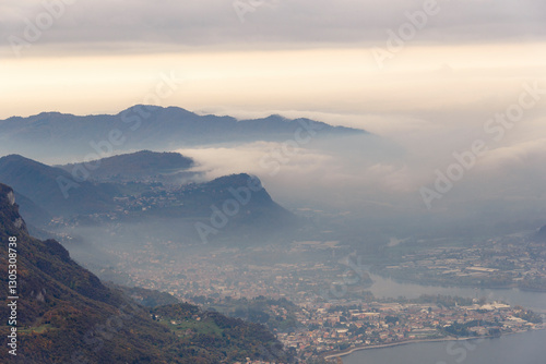 top view of the Como Lake from the Resinelli Piani in a foggy morning, Lecco province, Italy photo