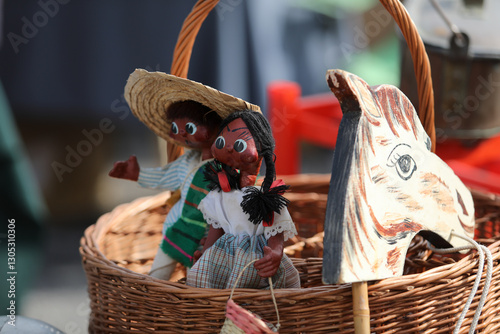 Lively flea market scene in France with vintage items, antiques, books, and decorations. People browsing and enjoying the atmosphere on a sunny day. European market culture captured in detail.