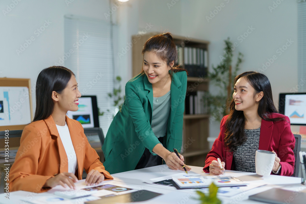Professional Asian businesswomen analyzing performance charts, collaborating with smiles during team meeting in contemporary workspace, highlighting corporate synergy Professional Asian businesswomen analyzing performance charts, collaborating with smiles during team meeting in contemporary workspace, highlighting corporate synergy