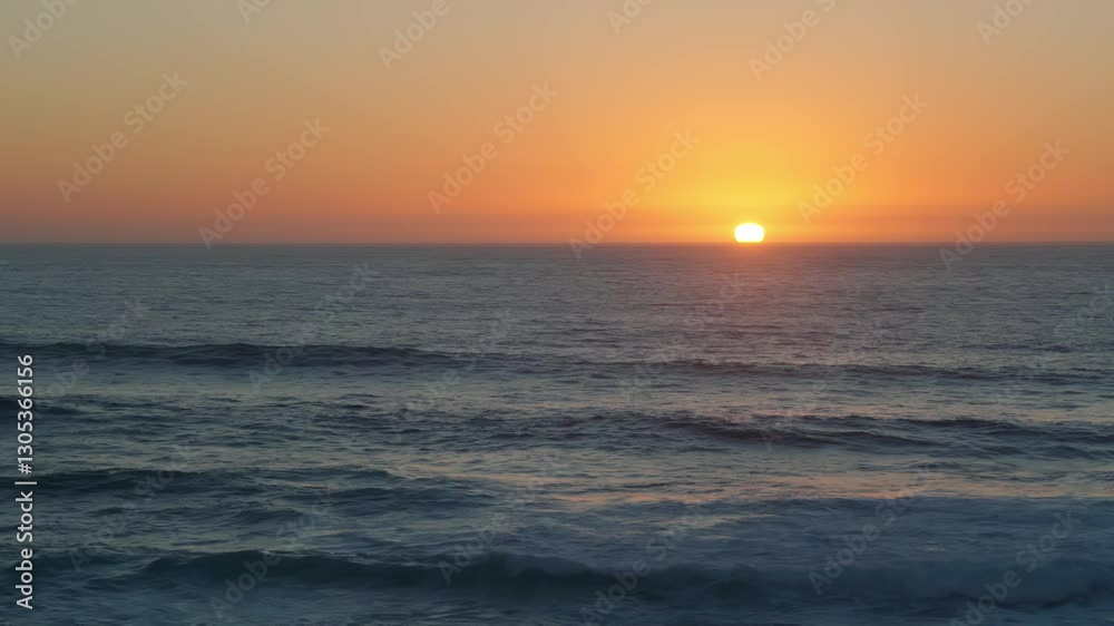 Golden sunset over the vast ocean gentle waves rolling towards the shore, sky blending warm orange and cool blue hues creating serene and peaceful seascape. Concept of tranquility and natures beauty Golden sunset over the vast ocean gentle waves rolling towards the shore, sky blending warm orange and cool blue hues creating serene and peaceful seascape. Concept of tranquility and natures beauty