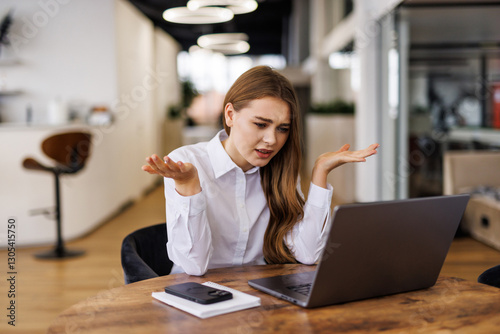 Young woman working on laptop having headache. Bored workaholic female accountant employee with headache and stress. photo