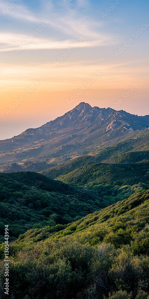 Low-hanging clouds settling over a mountain range at sunrise Low-hanging clouds settling over a mountain range at sunrise