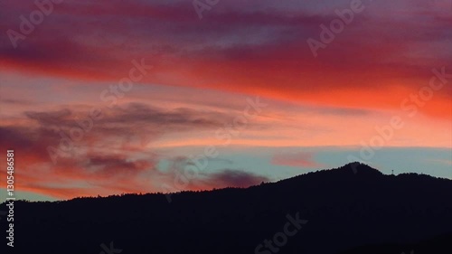 A dramatic sunset sky silhouettes the pine-studded ridge of the Greenhorn Mountains as seen from Kern Valley in California's southern Sierra Nevada.