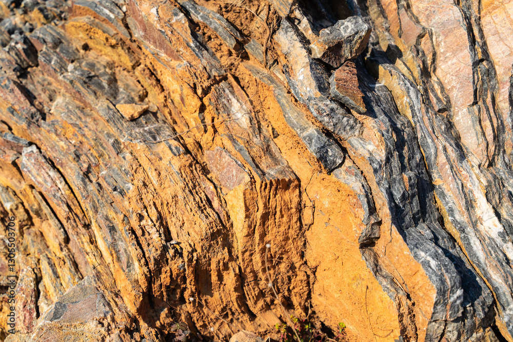 The background is a beautiful rough stone texture in close-up with bright colors of mineral inclusions The background is a beautiful rough stone texture in close-up with bright colors of mineral inclusions