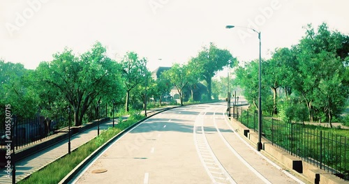 Wallpaper Mural A calm road curves through a lush green park, dotted with trees and greenery. The sunlight casts a warm glow, creating a tranquil atmosphere perfect for leisurely strolls. Torontodigital.ca