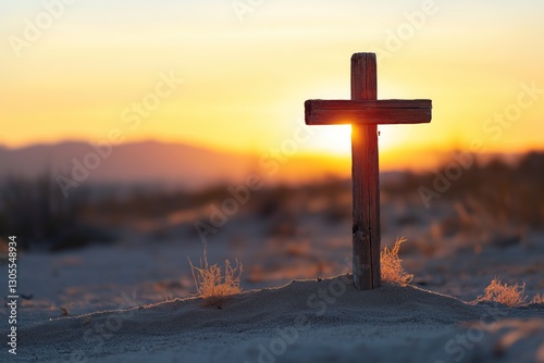Single rustic wooden cross standing in the middle of desert landscape. The wind is slightly shifting the sand at golden hour lighting, copy space. Solitude and peace. Good Friday concept.