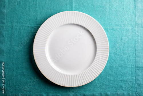 white plate on aqua linen , overhead