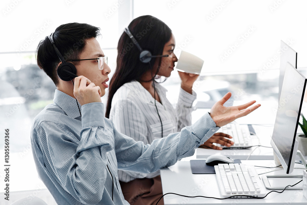 Team of customer service agents communicating with clients online in office Team of customer service agents communicating with clients online in office