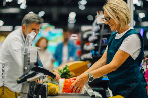 Supermarket cashier scanning groceries at checkout counter