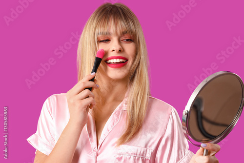 Young woman in pajamas with...