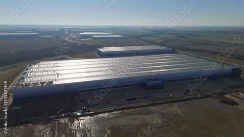 Gigafactory construction site expanding under sunlight