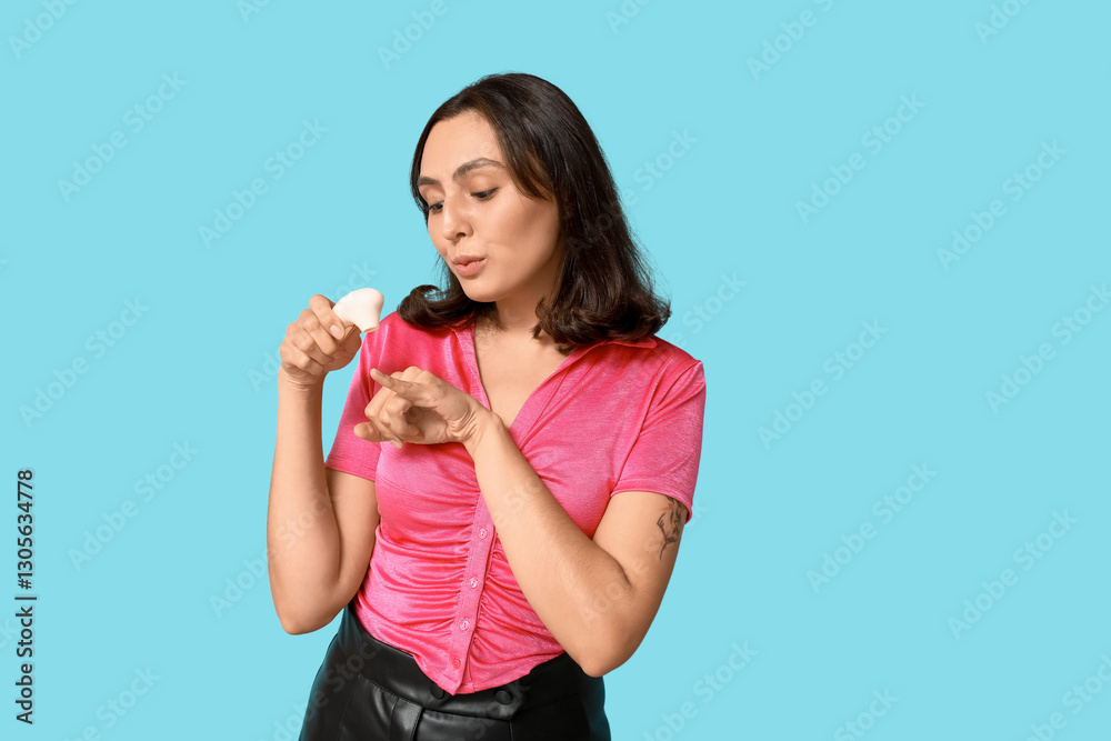 Beautiful young woman with vibrator on blue background Beautiful young woman with vibrator on blue background
