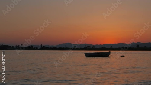 Wallpaper Mural Fish boat in the middle of dusk lake. A view of alone empty fishing boat on lake against bright sky in evening. Torontodigital.ca