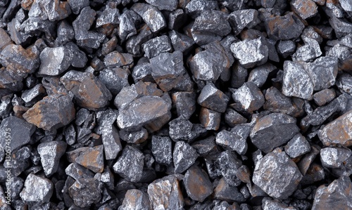Crushed iron ore background texture. Spherical lumps of crushed ore concentrate close-up. Semi-finished product of metallurgical production of iron. Iron-containing product of pelletizing and roasting