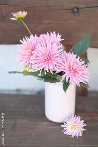 Wallpaper Mural Pink dahlia flowers arranged in a vintage vase resting on a rustic wooden bench create a charming still life composition, Torontodigital.ca
