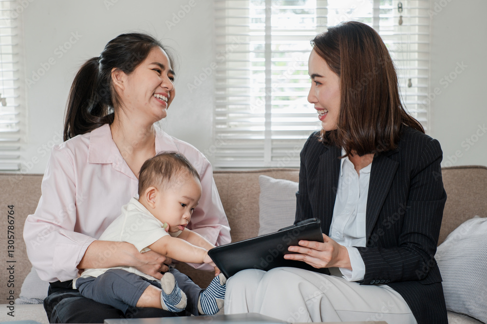 Businesswoman consulting with a mother and baby in a cozy living room, showcasing work-life balance and professional advice. Businesswoman consulting with a mother and baby in a cozy living room, showcasing work-life balance and professional advice.