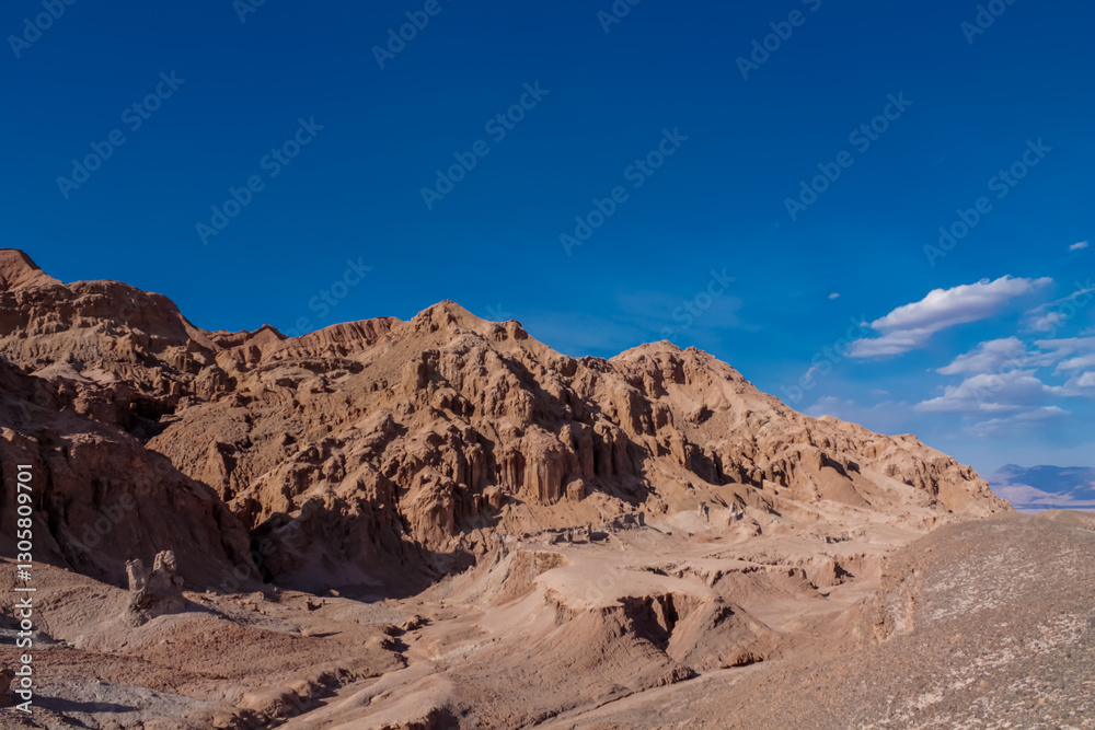 Moon valley famous desert landscape in Chile. Atacama desert tourist sight Valle de la Luna with stunning dry soil arid landscape of red rocks and sand under blue sky on Altiplano high altitude plain Moon valley famous desert landscape in Chile. Atacama desert tourist sight Valle de la Luna with stunning dry soil arid landscape of red rocks and sand under blue sky on Altiplano high altitude plain