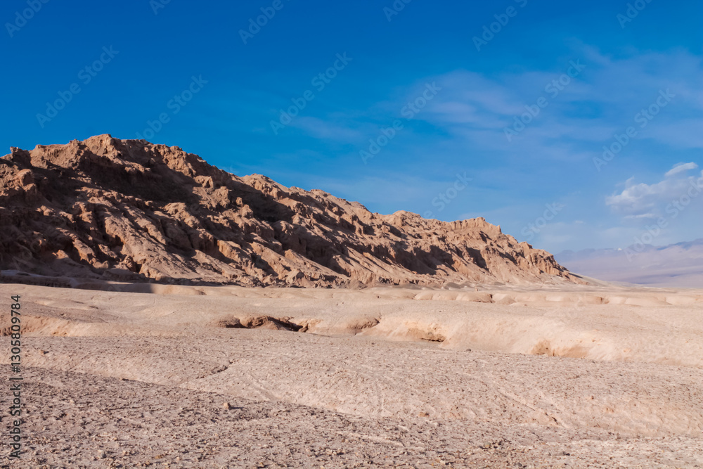 Moon valley famous desert landscape in Chile. Atacama desert tourist sight Valle de la Luna with stunning dry soil arid landscape of red rocks and sand under blue sky on Altiplano high altitude plain Moon valley famous desert landscape in Chile. Atacama desert tourist sight Valle de la Luna with stunning dry soil arid landscape of red rocks and sand under blue sky on Altiplano high altitude plain