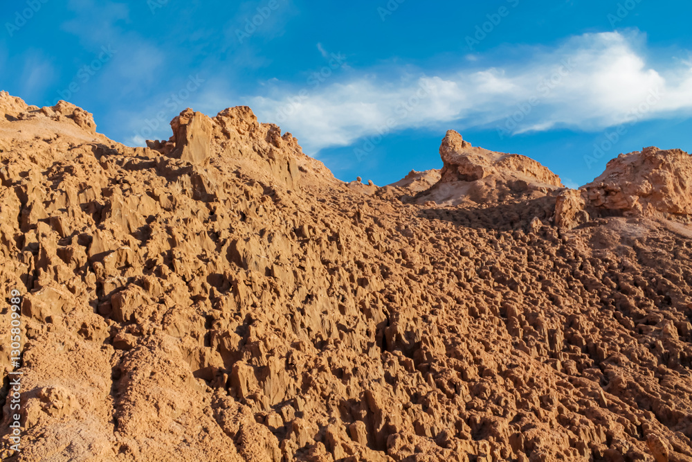 Moon valley famous desert landscape in Chile. Atacama desert tourist sight Valle de la Luna with stunning dry soil arid landscape of red rocks and sand under blue sky on Altiplano high altitude plain Moon valley famous desert landscape in Chile. Atacama desert tourist sight Valle de la Luna with stunning dry soil arid landscape of red rocks and sand under blue sky on Altiplano high altitude plain