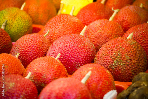 vibrant red gac fruits are gathered together