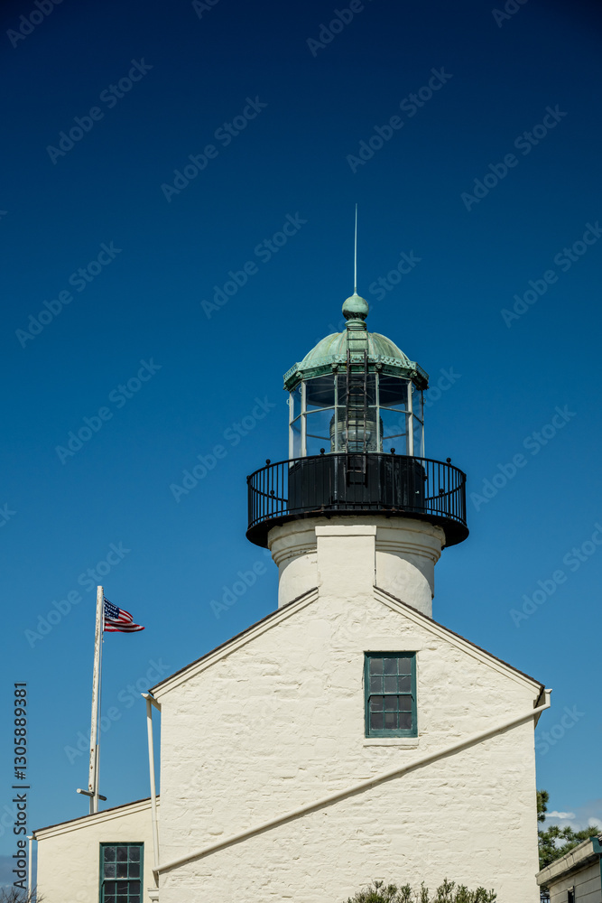 American Flag Flies Next To Cabrillo National Monument Against Blue Sky American Flag Flies Next To Cabrillo National Monument Against Blue Sky
