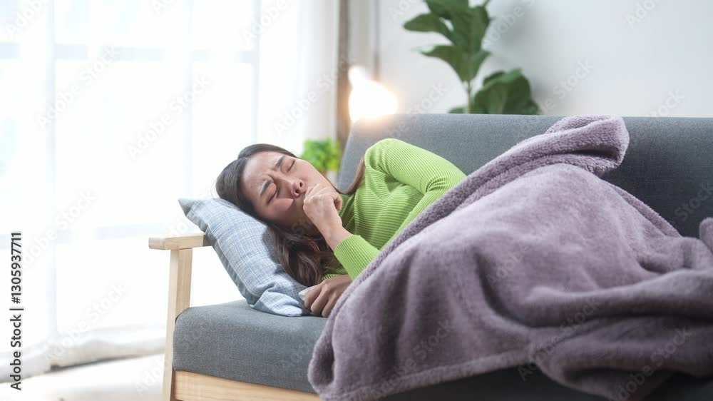 A woman is sleeping on a couch with a green shirt and a purple blanket. The room is dimly lit and has a cozy atmosphere A woman is sleeping on a couch with a green shirt and a purple blanket. The room is dimly lit and has a cozy atmosphere