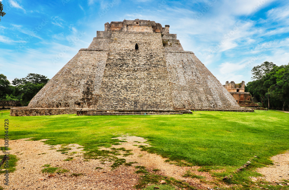 Great Pyramid of the Magician or Dwarf - East view of the Unique elliptical sided pyramid,built by the Uxmal Mayan rulers,6th to 10th century CE in Puuc style at Uxmal,Near Merida,Yucatan,Mexico Great Pyramid of the Magician or Dwarf - East view of the Unique elliptical sided pyramid,built by the Uxmal Mayan rulers,6th to 10th century CE in Puuc style at Uxmal,Near Merida,Yucatan,Mexico