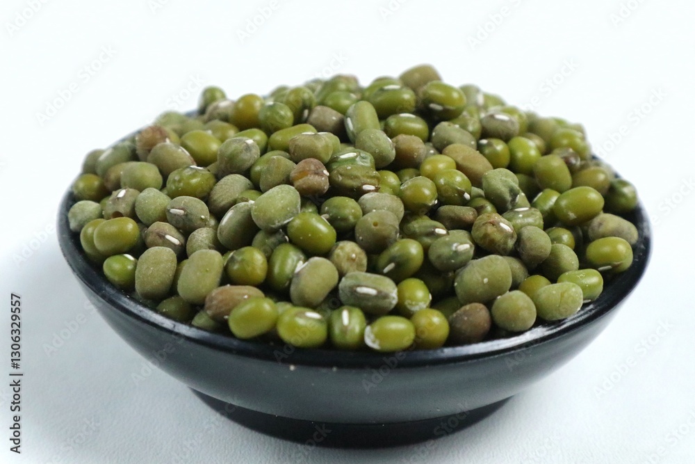 Green beans in black bowl isolated on white