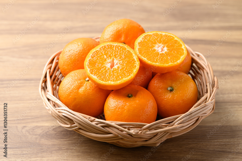 Mandarin tangerine orange fruit in basket on wooden background Mandarin tangerine orange fruit in basket on wooden background