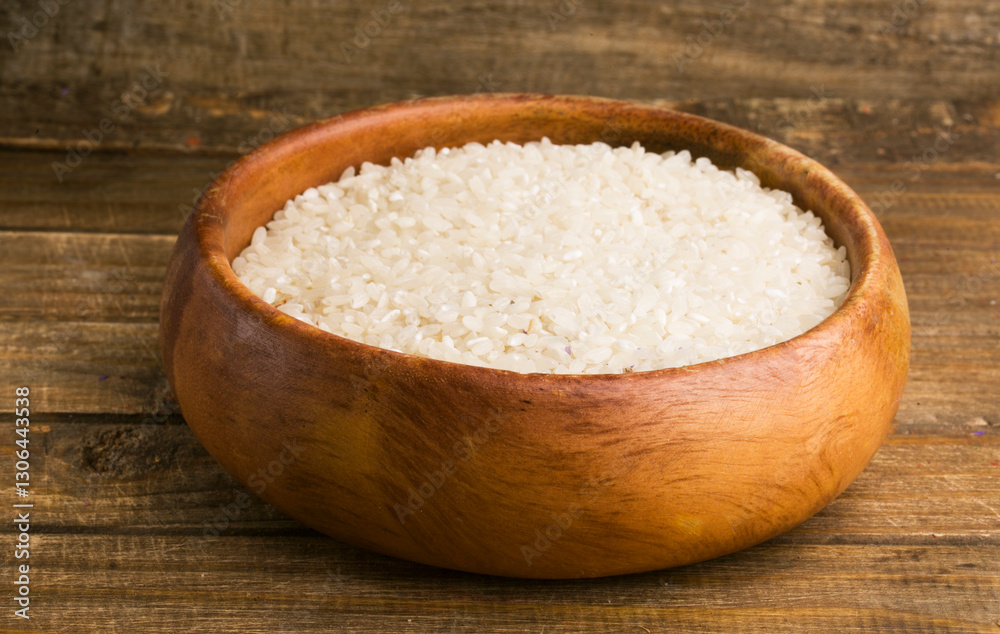 bowl of rice on wooden background