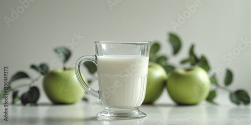 Glass Mug of Milk with Apples in Background