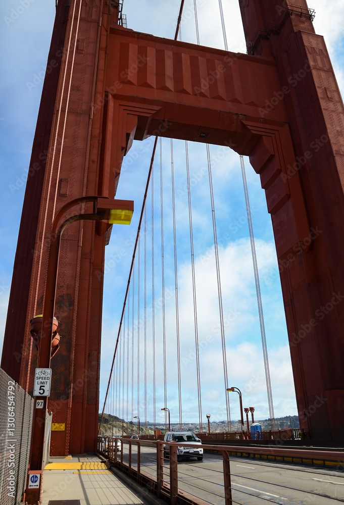 Obraz premium Beautiful view of the bridge supports of the famous Golden Gate Bridge with blue sky and clouds on a sunny summer day in San Francisco Bay Area, California, USA