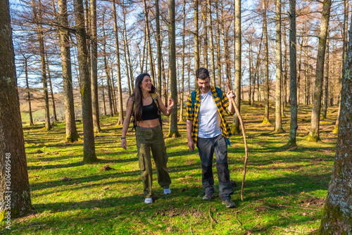 Hikers walking and smiling in sunny forest