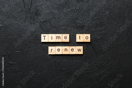 time to renew word written on wood block. time to renew text on table, concept