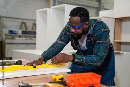 Afro american craftsman working as carpenter in a carpentry workshop