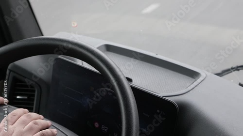 Closeup footage view of the passing road from the cab of the truck. All potential trademarks are  removed. 