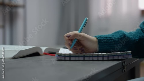 Young woman reading the Bible and making notes, symbolizing faith, devotion, and spiritual study.