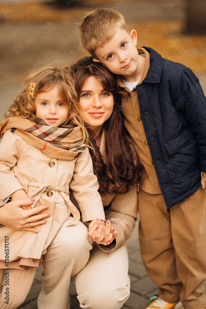 Mother and children enjoying a day out in the park during early autumn