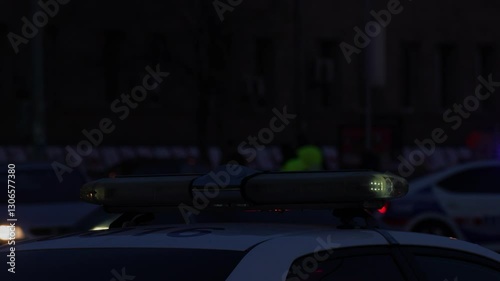 Flashing police car lights illuminating the evening streets in a festive Christmas city atmosphere.
