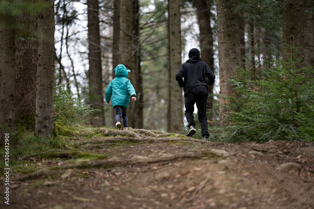 Children explore a serene forest trail while running and enjoying nature's beauty on a crisp afternoon amidst tall trees and vibrant greenery Children explore a serene forest trail while running and enjoying nature's beauty on a crisp afternoon amidst tall trees and vibrant greenery
