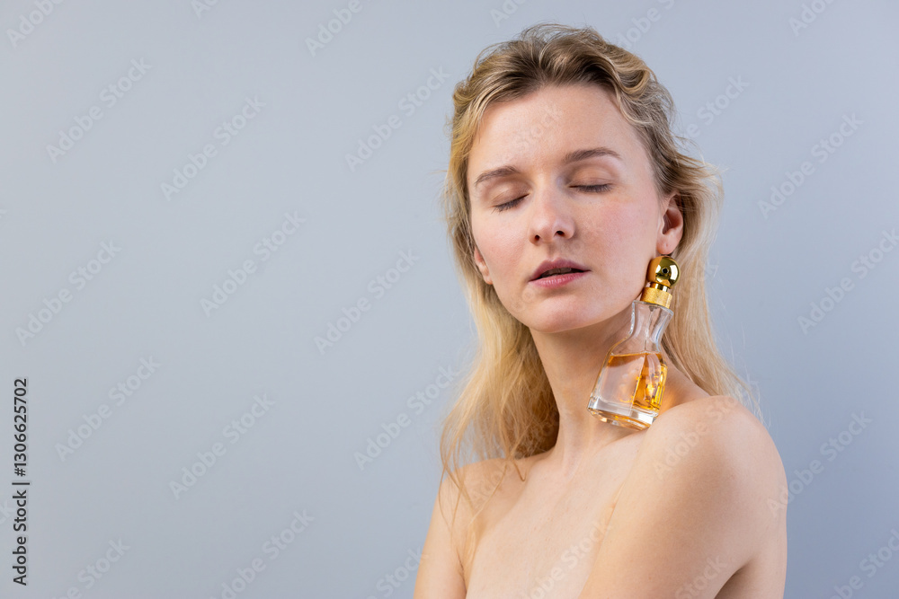 Graceful Beauty: Captivating Portrait of a Woman with a Unique Bottle-Shaped Earring Against a Soft Gray Background Graceful Beauty: Captivating Portrait of a Woman with a Unique Bottle-Shaped Earring Against a Soft Gray Background