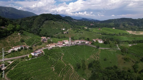 DRONE FOOTAGE: Famous Prosecco Hills in Veneto wine region. View of vineyard Prosecco and the Chiesa di Rolle church in Rolle, a small hamlet of Cison di Valmarino, Valdobbiadene, Veneto, Italy.