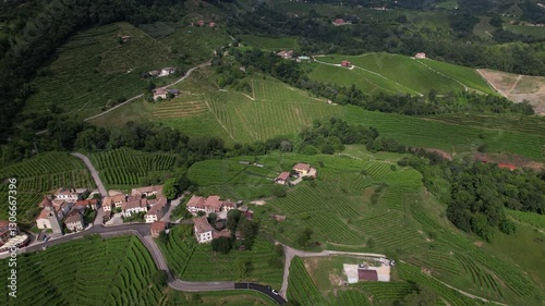 DRONE FOOTAGE: Famous Prosecco Hills in Veneto wine region. View of vineyard Prosecco and the Chiesa di Rolle church in Rolle, a small hamlet of Cison di Valmarino, Valdobbiadene, Veneto, Italy.