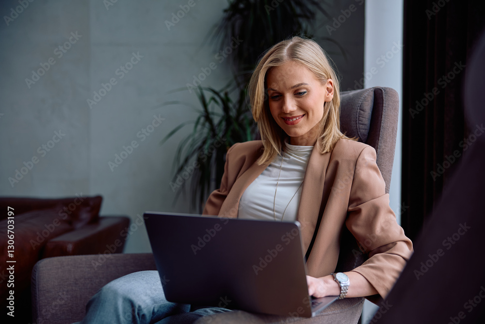 Happy entrepreneur using computer while working at her office. Happy entrepreneur using computer while working at her office.