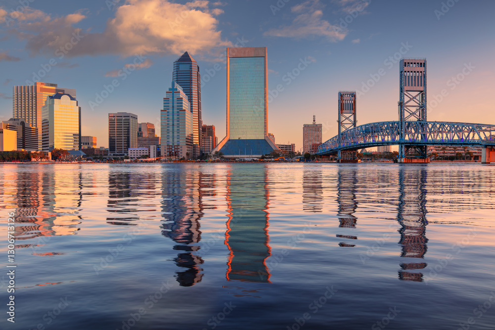Jacksonville, Florida, USA. Cityscape image of Jacksonville, Florida with reflection of the city skyline in the water at beautiful sunrise.