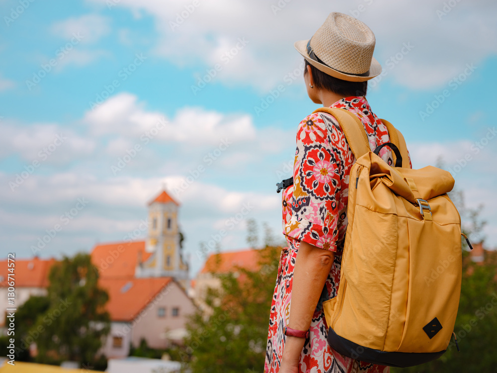 Obraz premium Beautiful woman walking of Varazdin streets during summer day in old, historical city center. Tourist exploring the beautiful streets, view on city from fortess